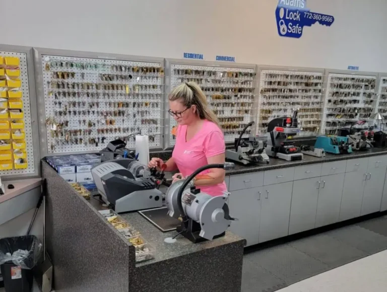 Locksmith shop interior with employee cutting keys in Vero Beach